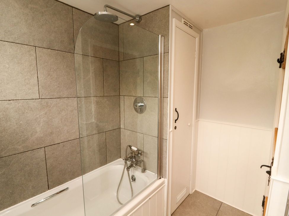 A bathroom with a bathtub and shower at Byways Ambleside