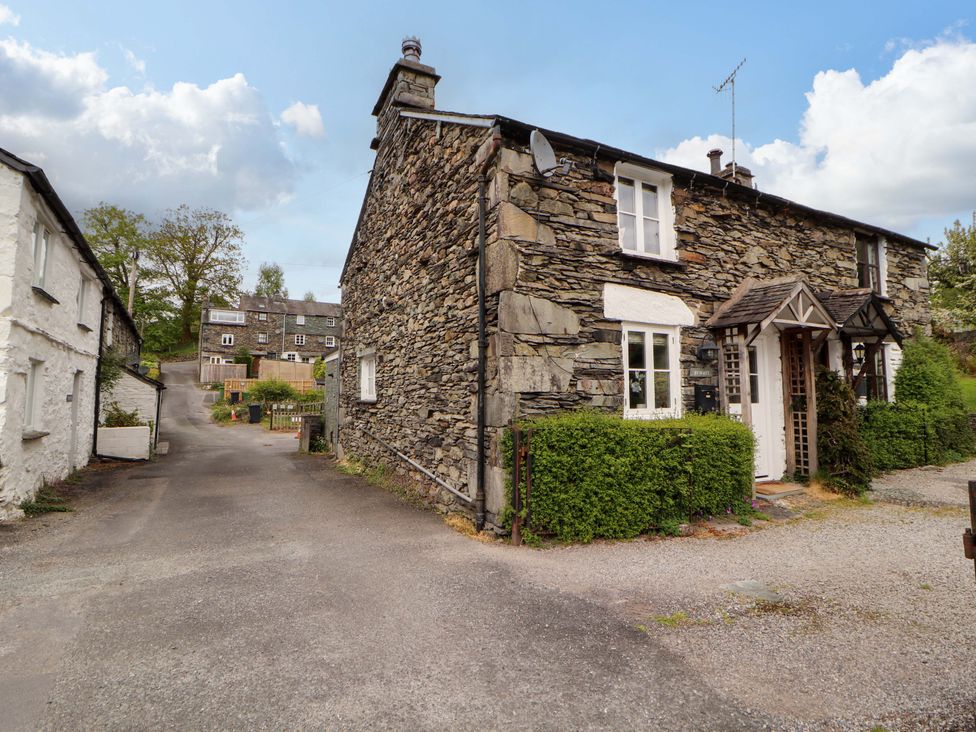 A stone house with a pathway and garden at Byways Ambleside
