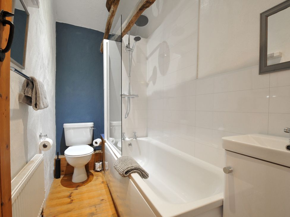 A bathroom with a bath shower and toilet at Skiber Long in Bray Shop near Launceston