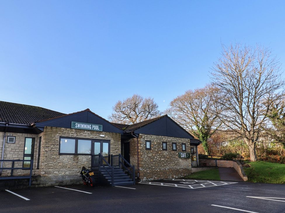 An outdoor area with a swimming pool and cafe at Tri-Star House in Charmouth