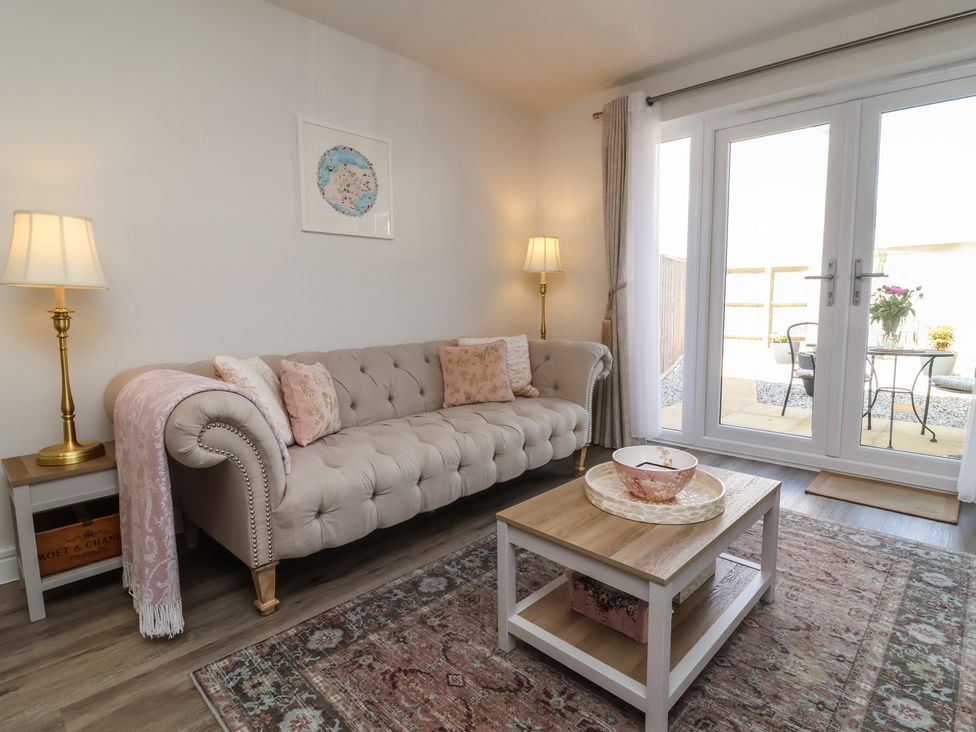 A living room with a sofa and coffee table at Seashell Sands in Appledore