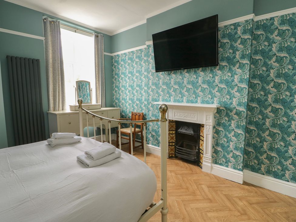 A bedroom with a bed and television at Noah's Rest in Llandudno