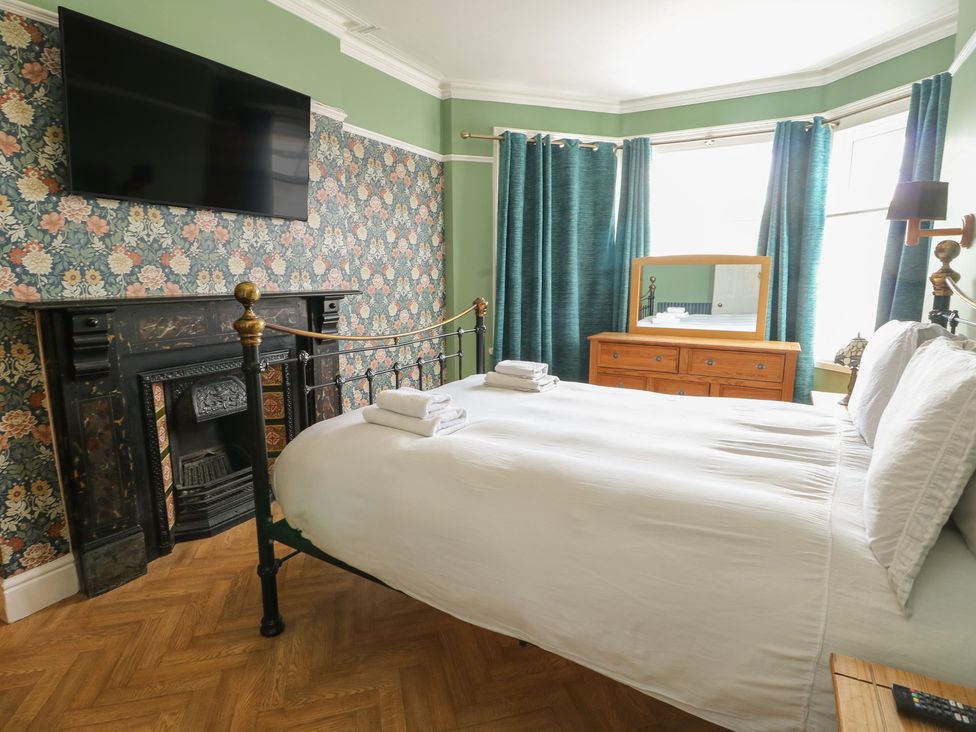 A bedroom with a bed and television at Noah's Rest in Llandudno