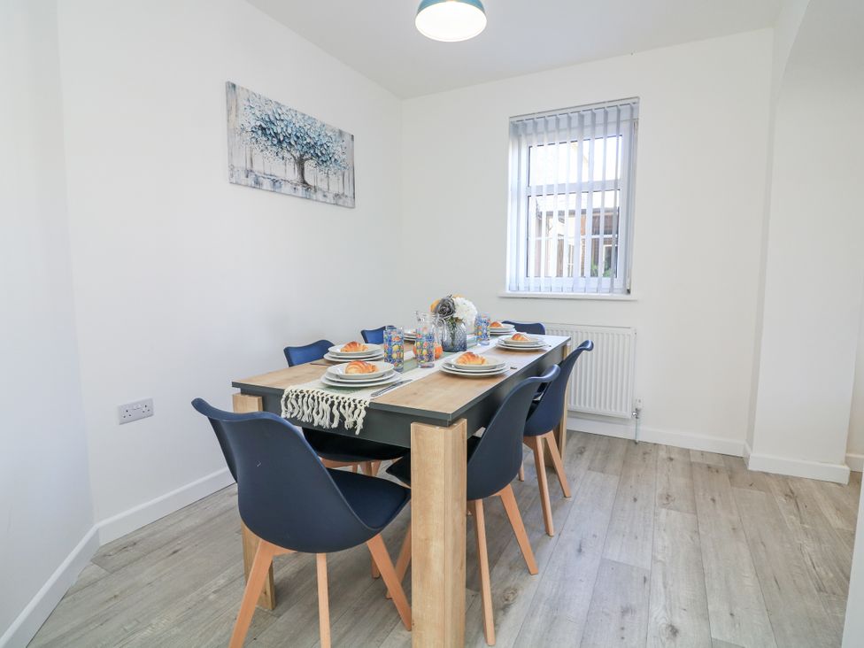 A dining room with a table set for meals at Hougoumont Cottage Torpoint