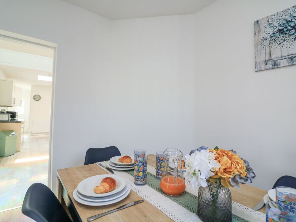 A dining room with a table set for breakfast at Hougoumont Cottage in Torpoint