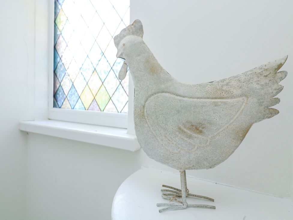 A chicken figurine beside a window at Hougoumont Cottage in Torpoint