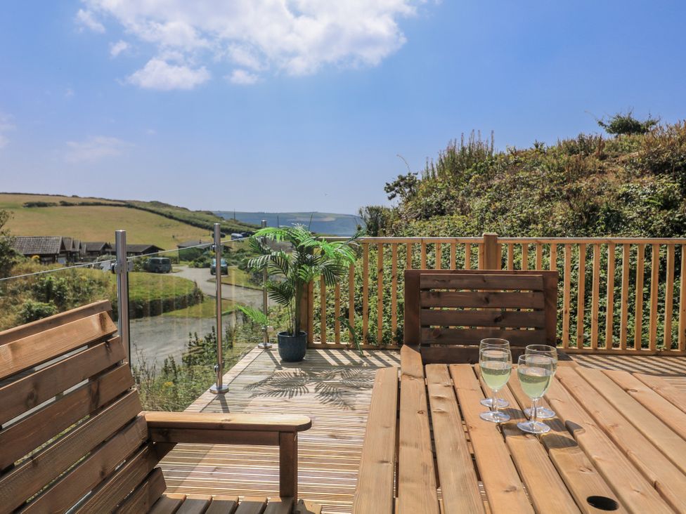A deck with a table and chairs at Hougoumont Cottage in Torpoint