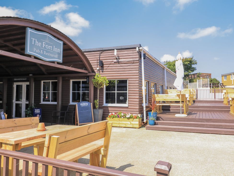 An outdoor seating area with tables at The Fort Inn in Torpoint