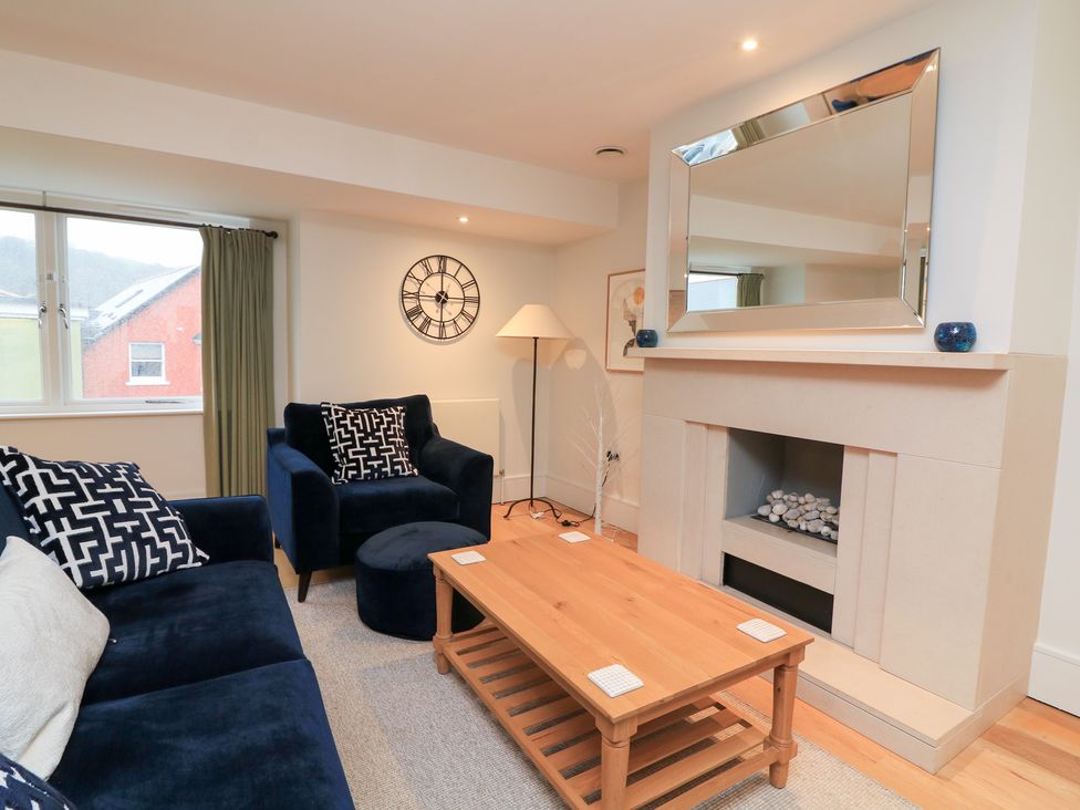 A living room with a sofa and armchair at 39 Dart Marina in Dartmouth