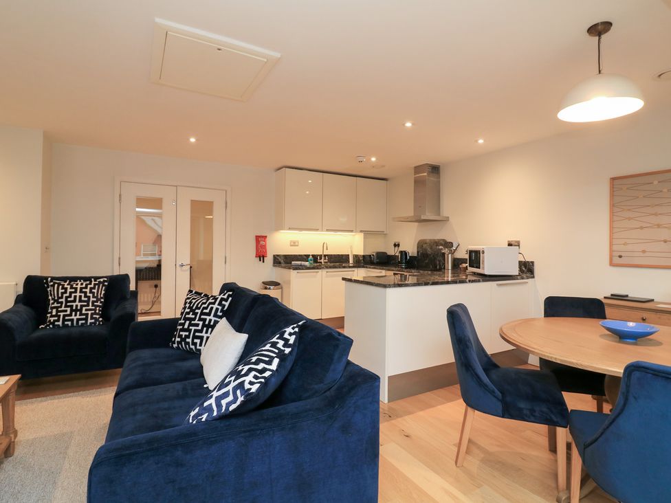 A living room with sofa and dining table at 39 Dart Marina Dartmouth