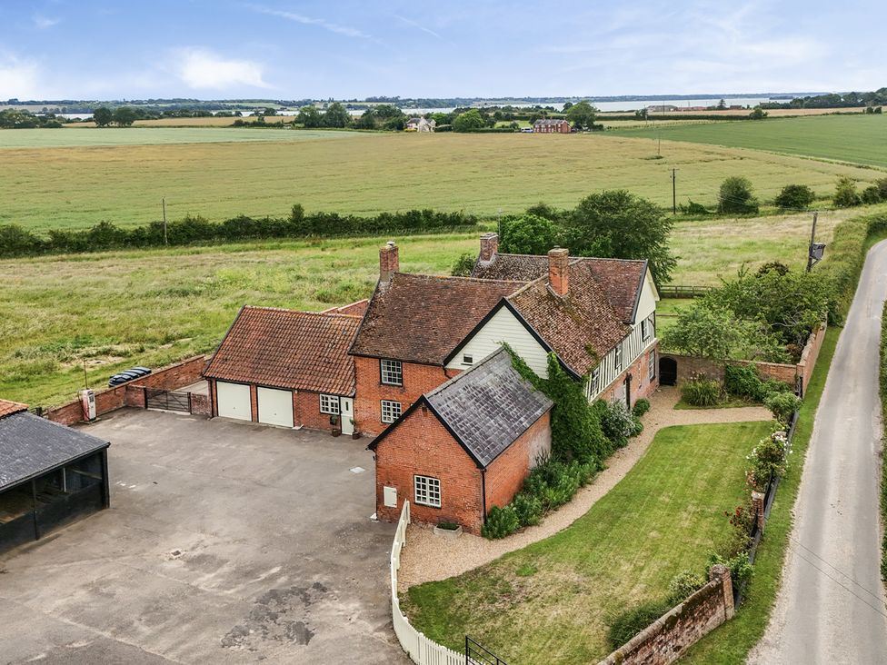An exterior view of a house with a garage and garden at Knights Farm in Harkstead