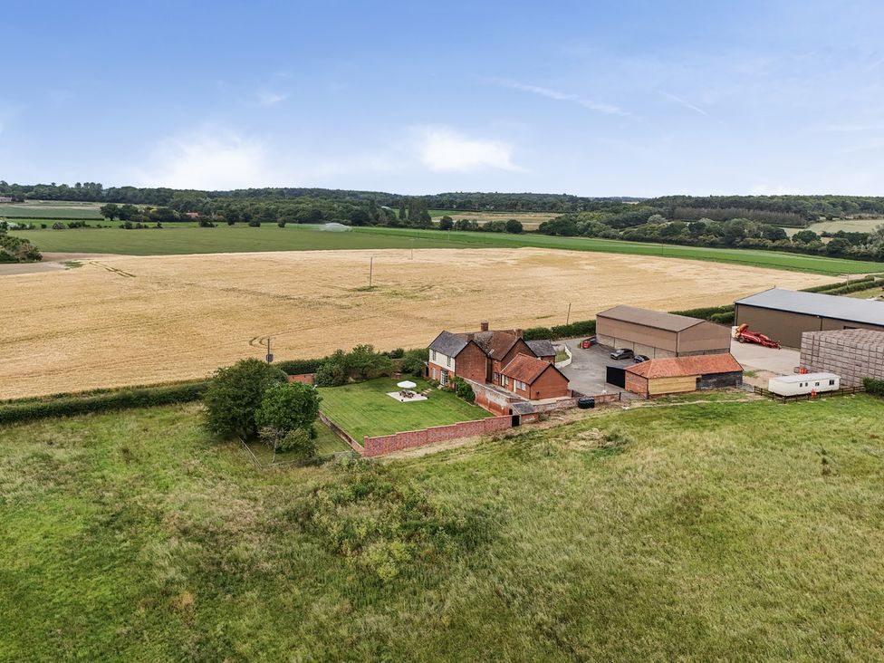 A farm with a house and surrounding fields at Knights Farm in Harkstead