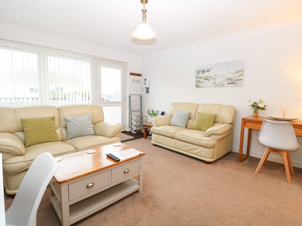 A living room with sofas and a coffee table at 19 Waterside Park in Corton