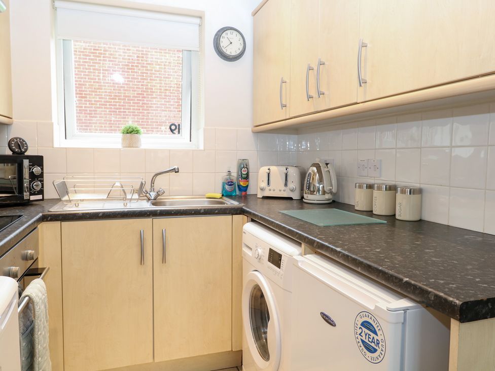 A kitchen with appliances and a sink at 19 Waterside Park in Corton