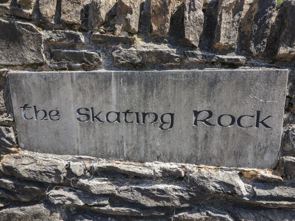 An engraved sign that reads the Skating Rock on a stone wall at The Skating Rock Bunane near Kenmare, County Kerry
