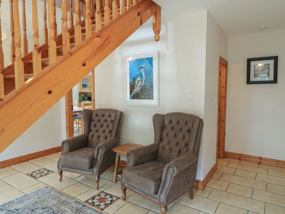 A hallway with two armchairs and a small table at The Skating Rock in Bunane near Kenmare, County Kerry