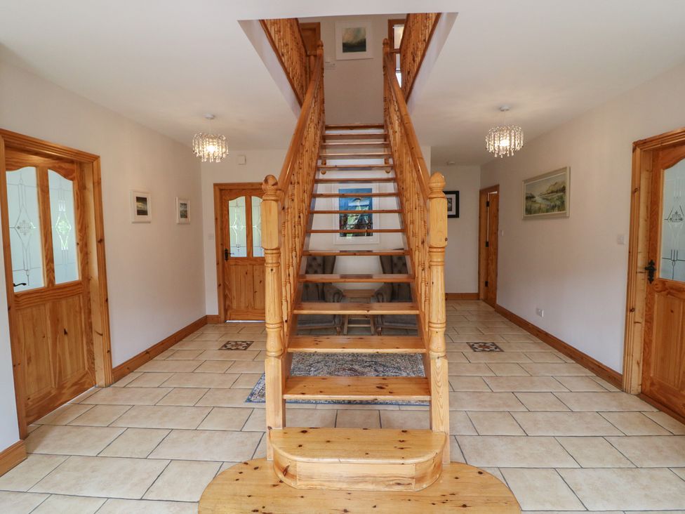 A hallway with a staircase and doors at The Skating Rock in Bunane near Kenmare, County Kerry