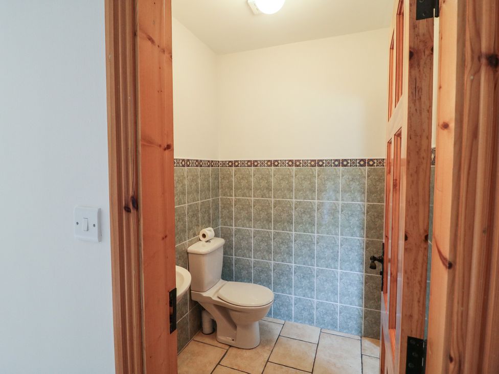 A bathroom with a toilet and tiles at The Skating Rock in Bunane near Kenmare, County Kerry