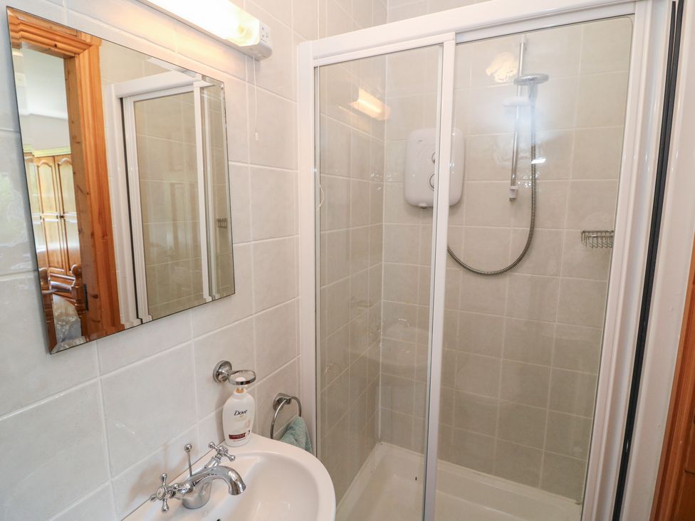 A bathroom with a shower and sink at The Skating Rock in Bunane near Kenmare, County Kerry