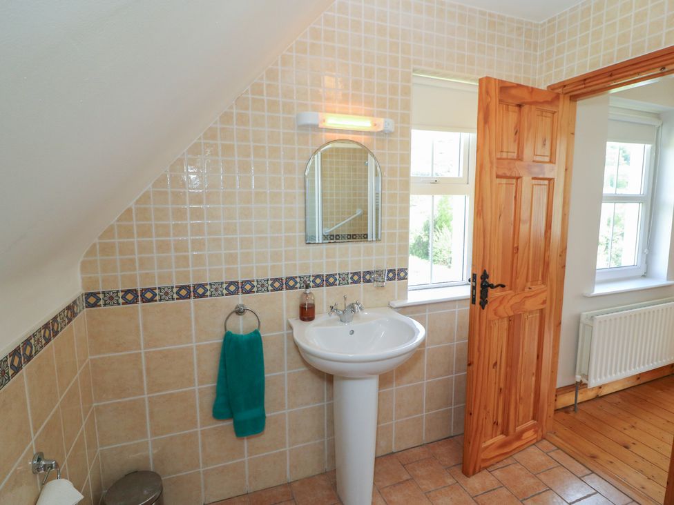 A bathroom with sink and mirror at The Skating Rock in Bunane near Kenmare County Kerry