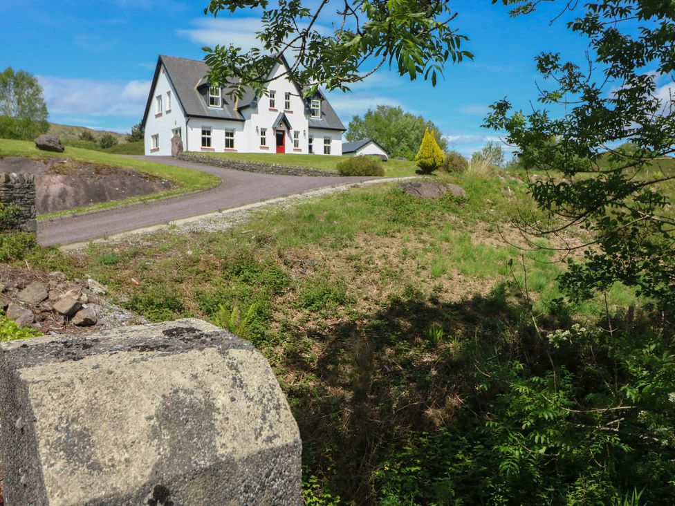 A house with a driveway and landscaping at The Skating Rock in Bunane near Kenmare, County Kerry