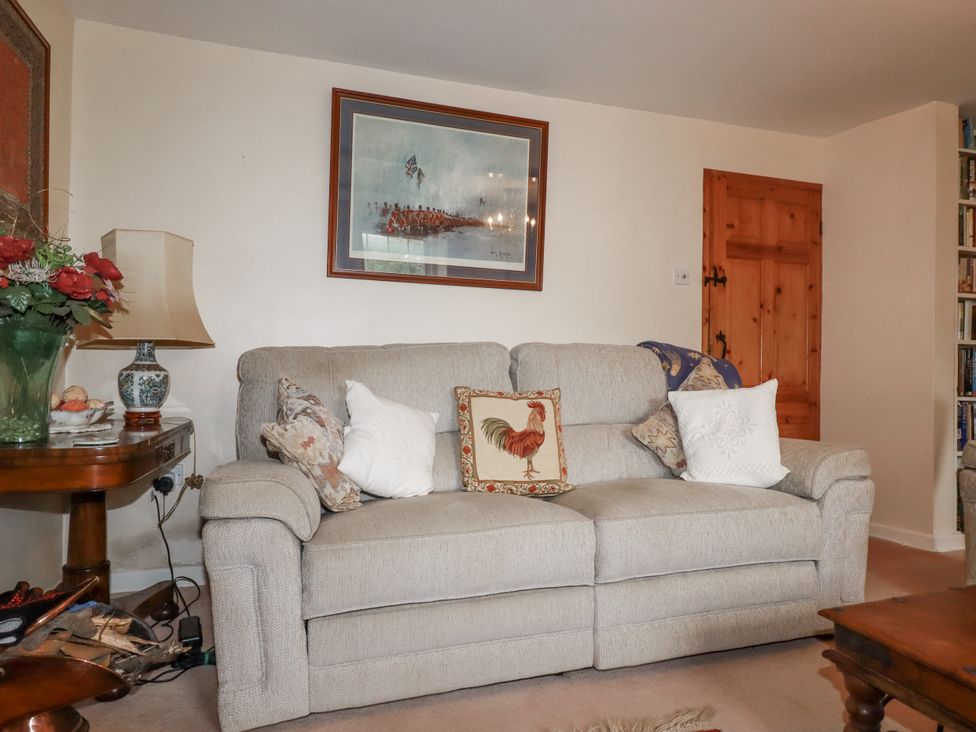 A living room with a sofa and a table at Temple House Goonhavern