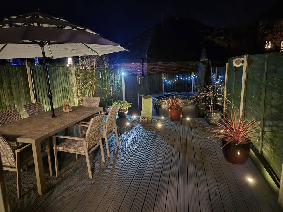 A patio with a table, chairs, and a hot tub at 63 Severn Street, Bridgnorth