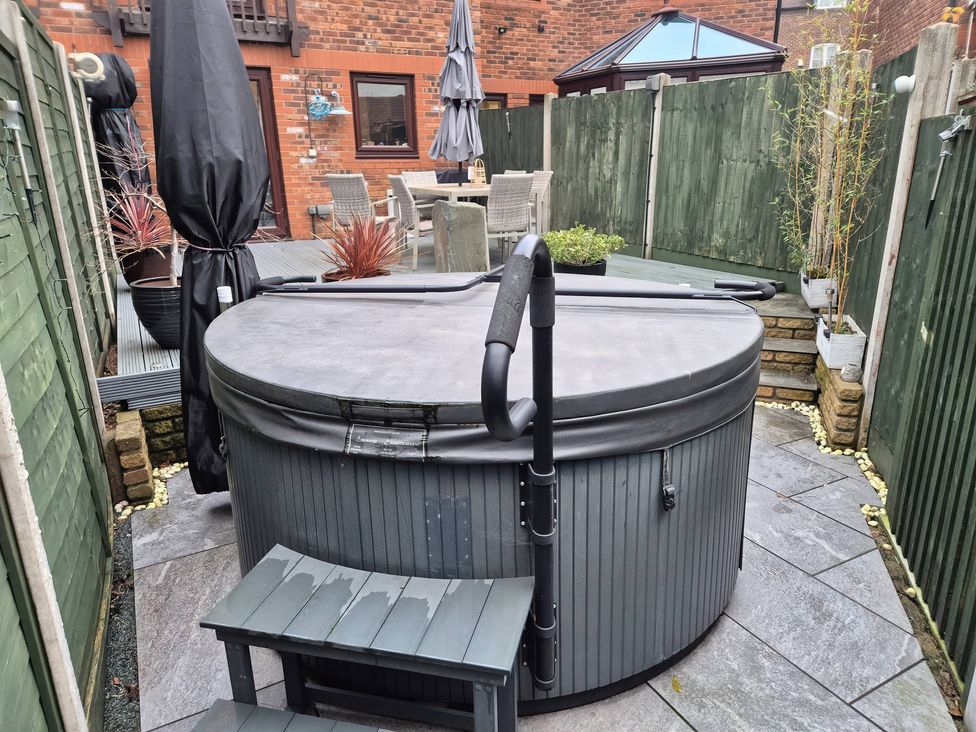 A hot tub with a patio and outdoor furniture at 63 Severn Street in Bridgnorth