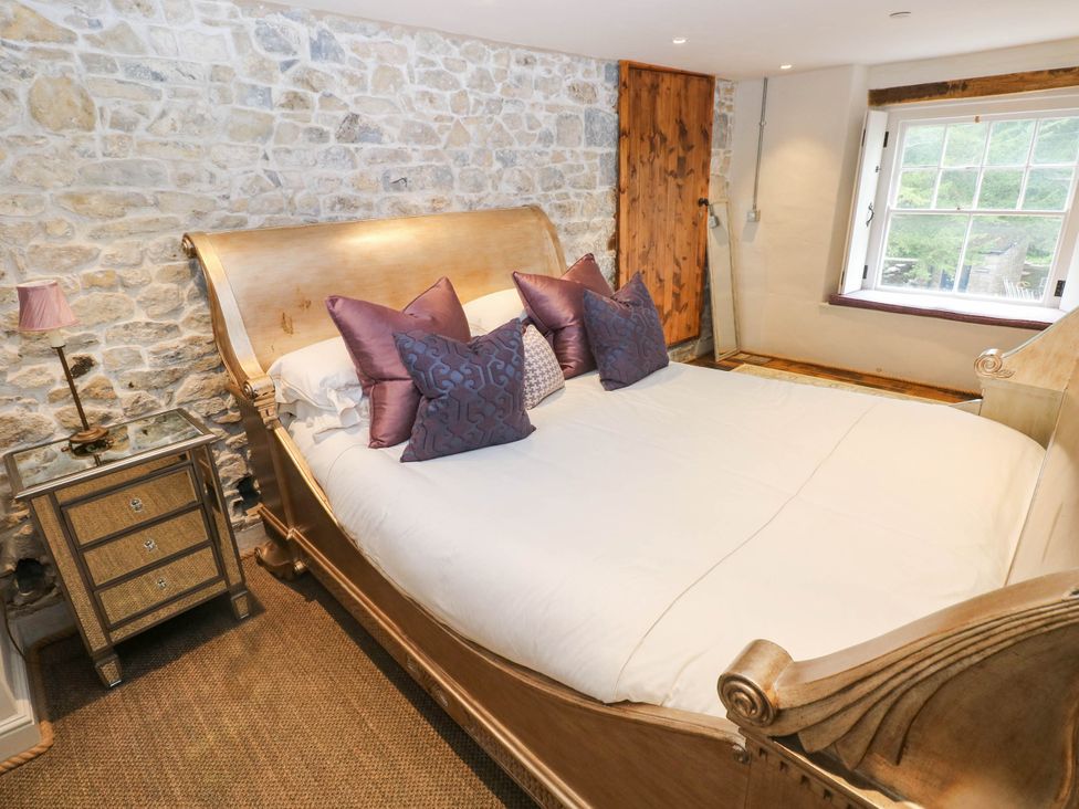 A bedroom with a bed and nightstand at The Apple Store at Gileston Manor