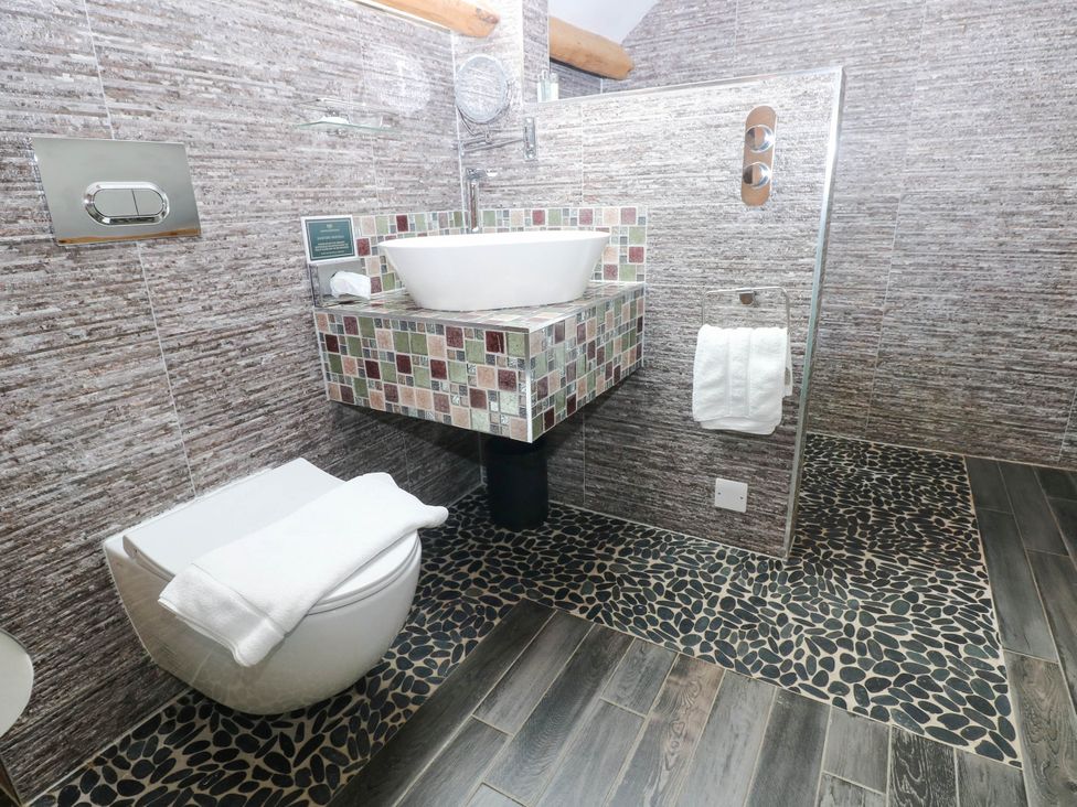 A bathroom with a toilet and sink at The Apple Store at Gileston Manor near St Athan