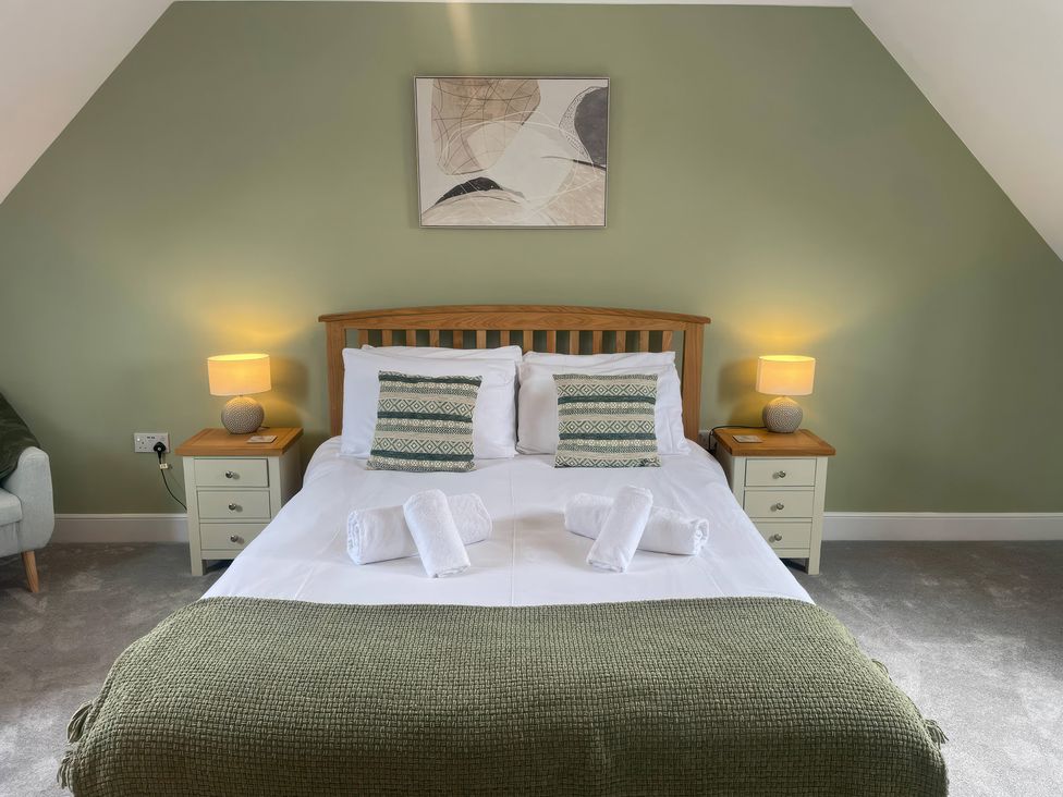 A bedroom with a bed and bedside tables at Plain Sailing in Weymouth