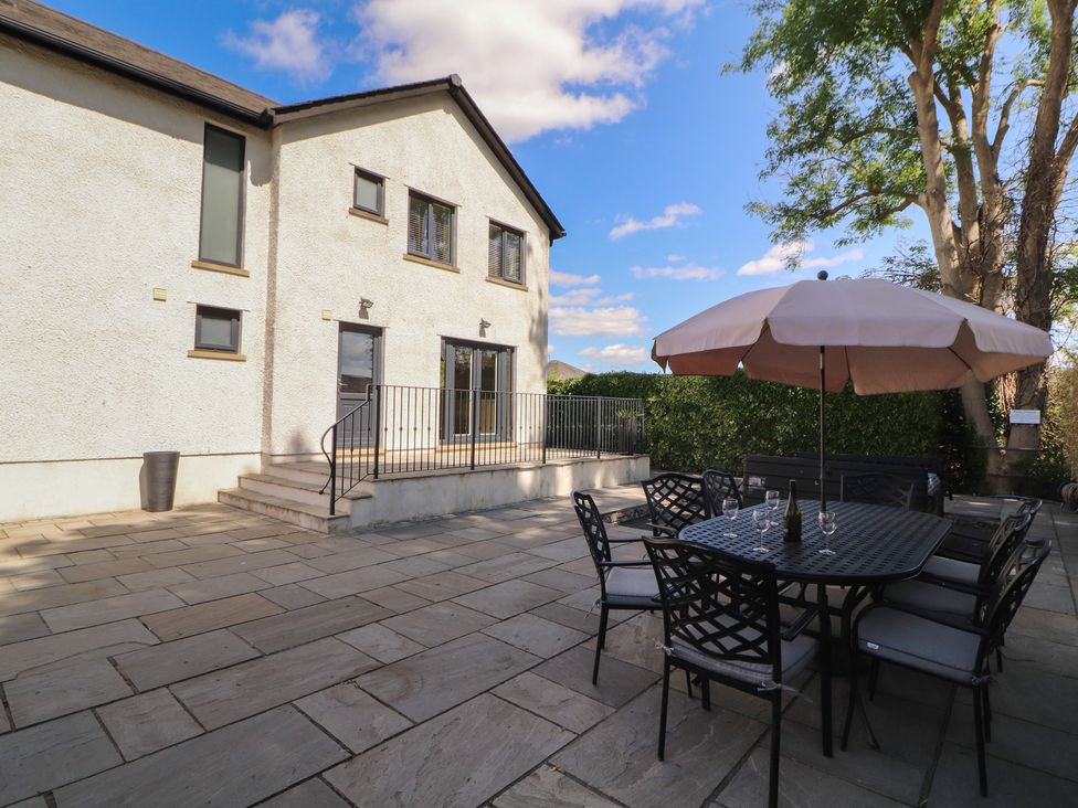 A patio area with a dining table and chairs at Ingleborough in Kirkby Lonsdale