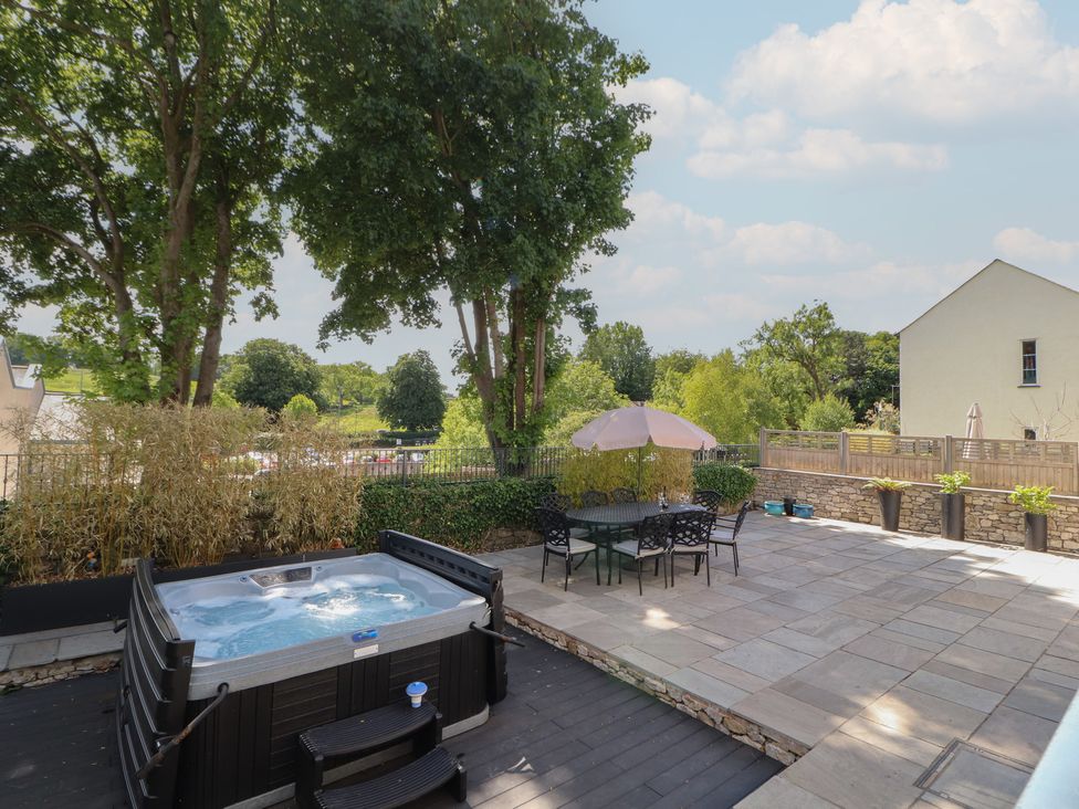 An outdoor area with a hot tub and seating at Ingleborough in Kirkby Lonsdale