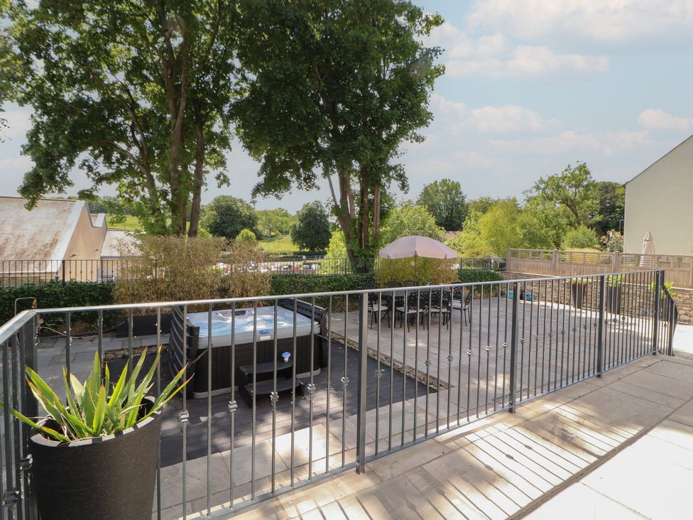 An outdoor area with a hot tub and seating at Ingleborough in Kirkby Lonsdale