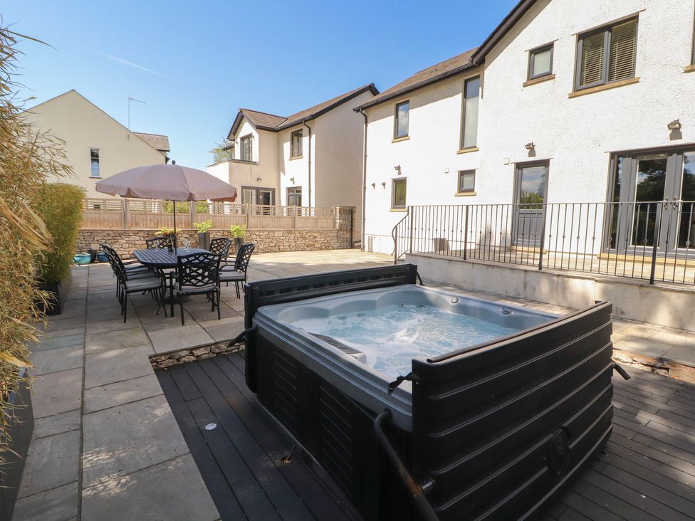 An outdoor area with a hot tub and dining set at Ingleborough in Kirkby Lonsdale