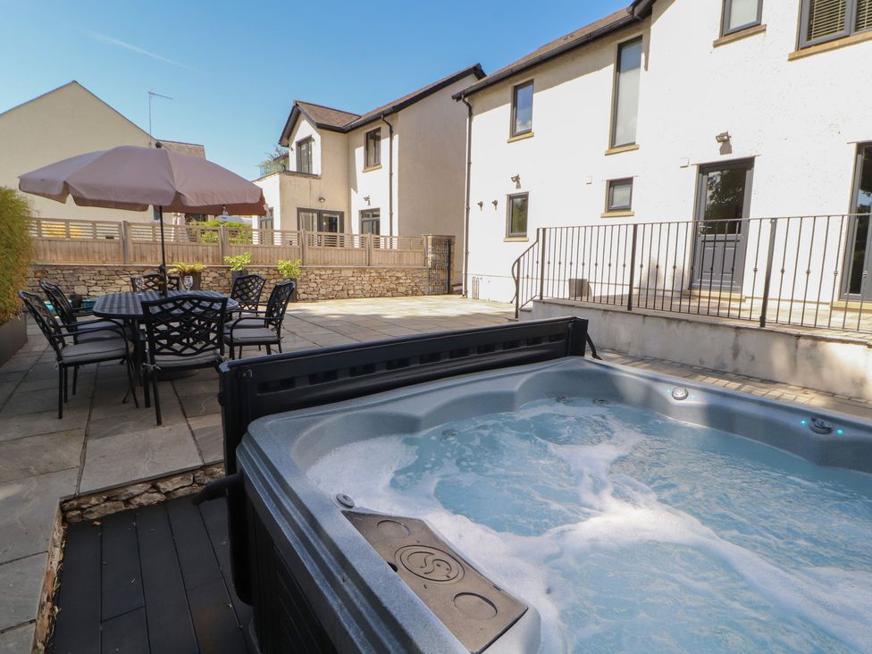 A garden with a hot tub and outdoor furniture at Ingleborough in Kirkby Lonsdale