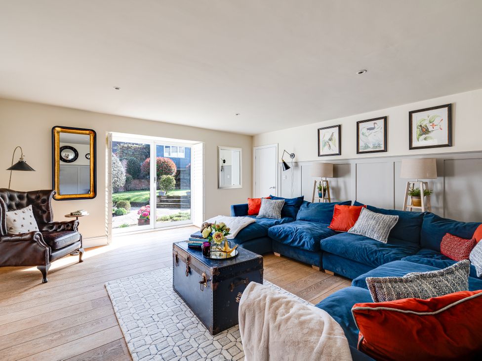 A living room with a sofa, table and lamp at The Old Chase in Chester