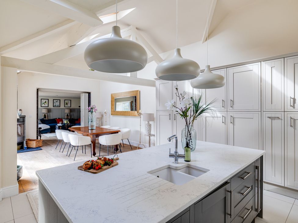 A kitchen with an island and dining area at The Old Chase in Chester