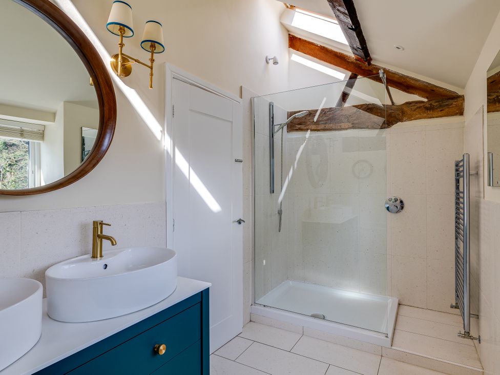 A bathroom with a shower and wash basins at The Old Chase in Chester