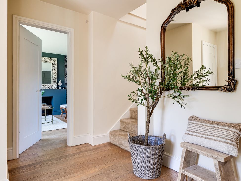 A hallway with a mirror and a plant at The Old Chase in Chester