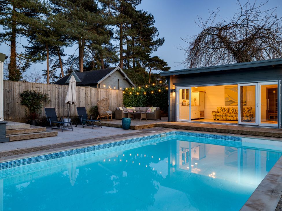 An outdoor area with a swimming pool and sun loungers at The Old Chase in Chester