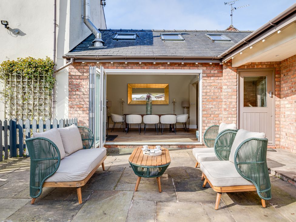 An outdoor seating area with chairs and a table at The Old Chase in Chester