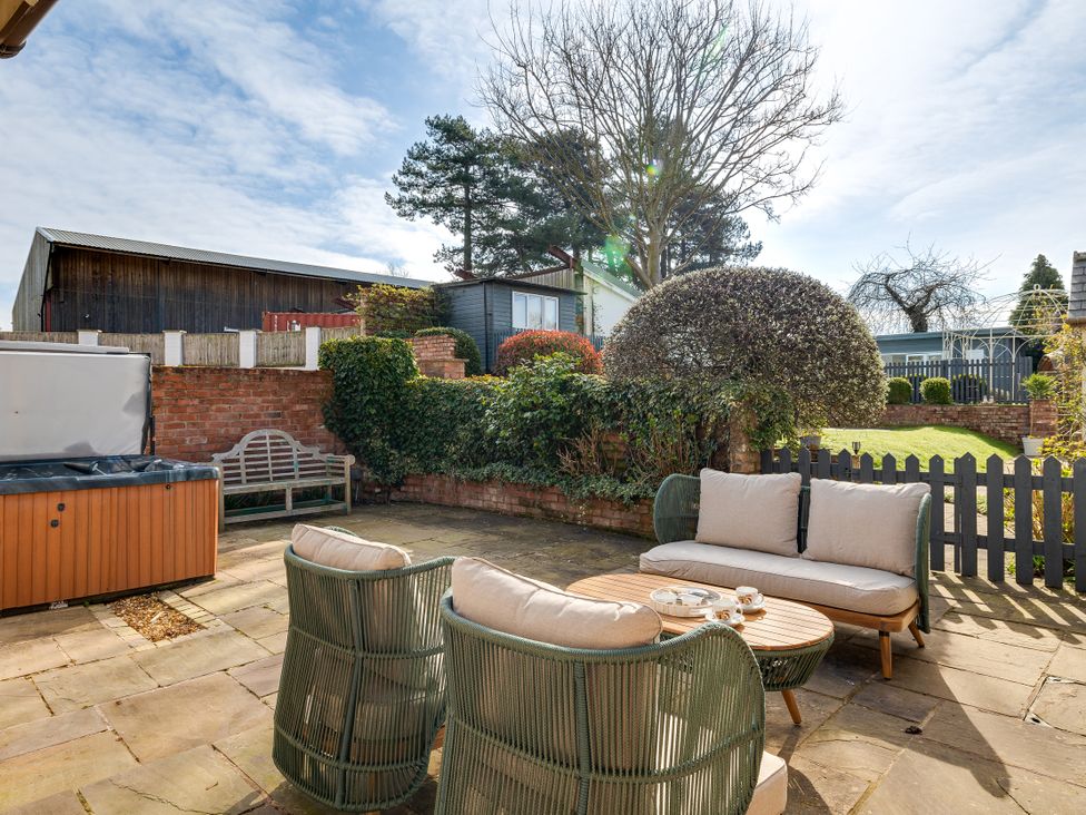 A garden with a seating area and hot tub at The Old Chase in Chester