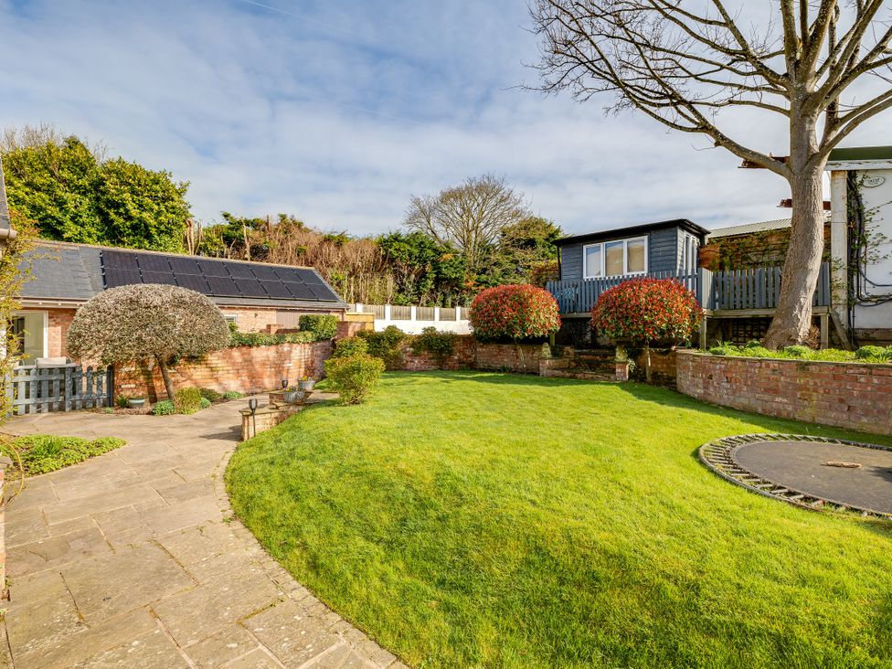 A garden with lawn and flower beds at The Old Chase in Chester
