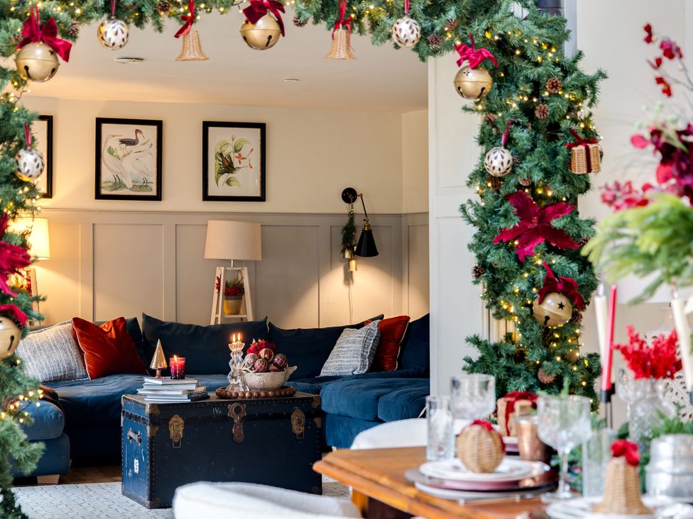 A living room with a blue sofa and decorative items at The Old Chase in Chester
