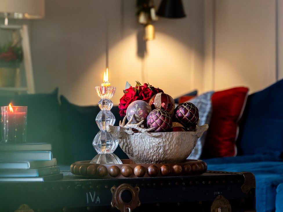 A decorative arrangement on a coffee table with candles and ornaments at The Old Chase Chester
