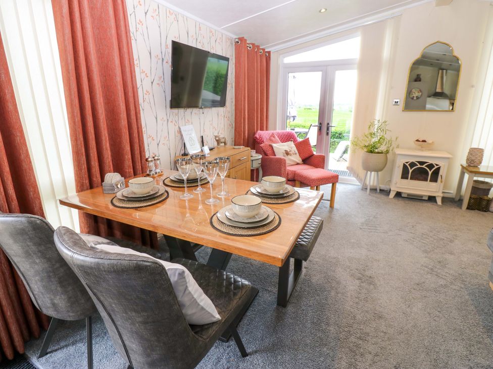 A dining room with a table set for a meal at Plot 32 High Hesket near Armathwaite
