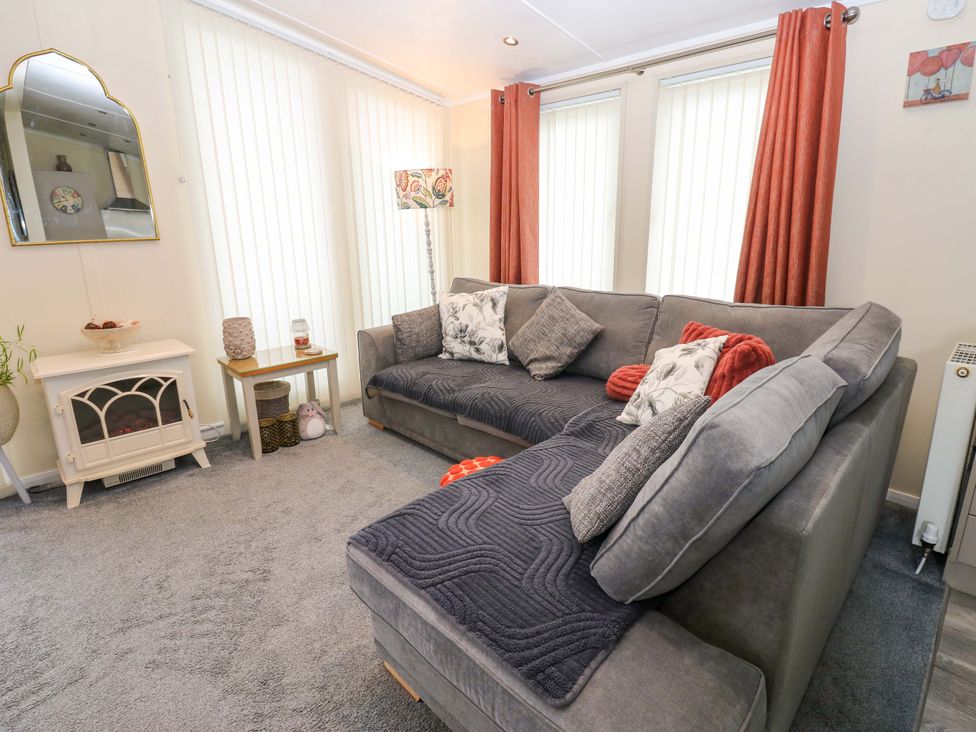 A living room with a sofa and coffee table at Plot 32 in High Hesket near Armathwaite