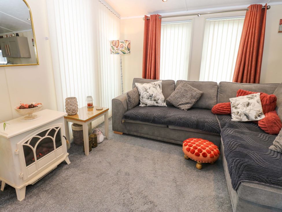 A living room with a sofa and decorative items at Plot 32 High Hesket near Armathwaite