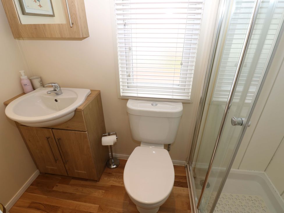 A bathroom with a sink, toilet, and shower at Plot 32 High Hesket near Armathwaite